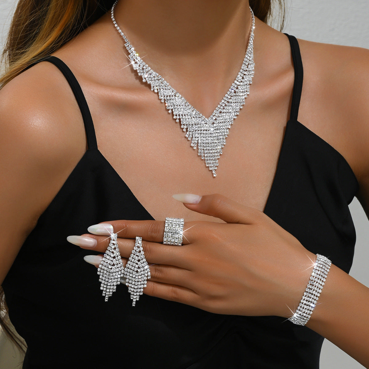 Sophisticated and moody. This works perfectly for prom, evening weddings, or black-tie events where the jewelry needs to pop against dark evening wear